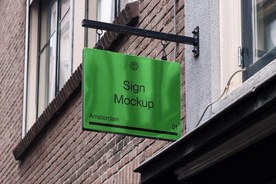 Green sign mockup hanging on a brick wall exterior, urban setting for graphic design presentation.